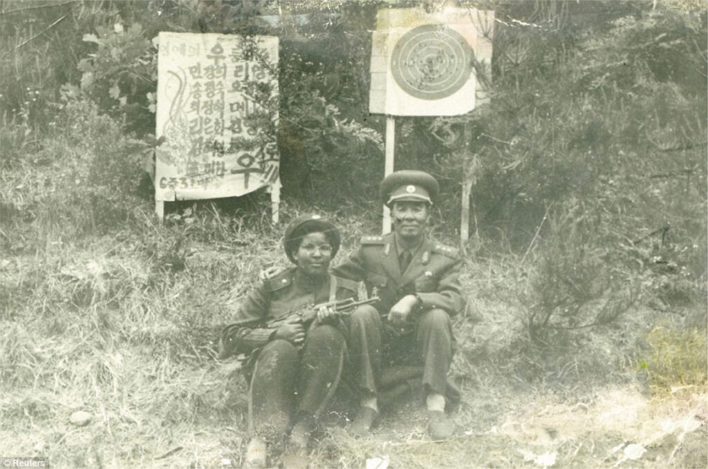 Monica with Director O and her weapon during training camp