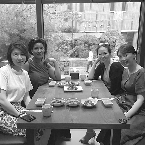Monica at a meal with friends and colleagues in Seoul