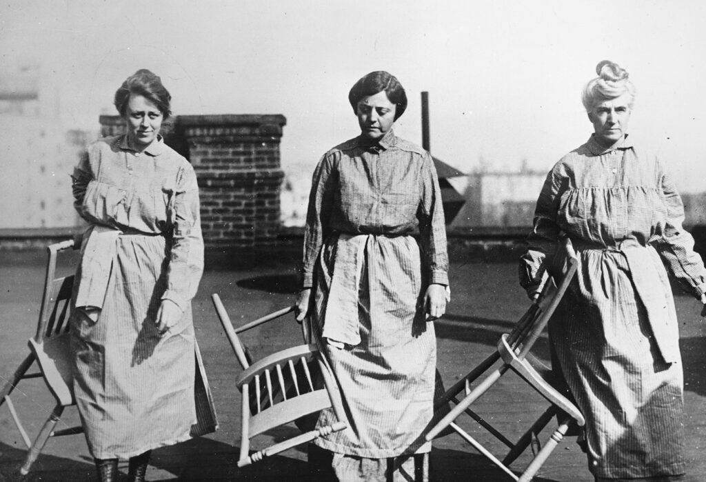 Heterodoxy members Doris Stevens, Alison Turnbull Hopkins, and another elite suffragist, Eunice Dana Brannan, dressed in their prison uniforms, photographed during their detention at Occoquan Workhouse, Virginia